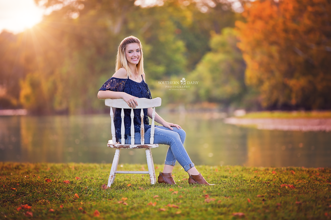 Senior Girl sitting on chair in front of creek - fall colors - Hendersonville Senior Photographer