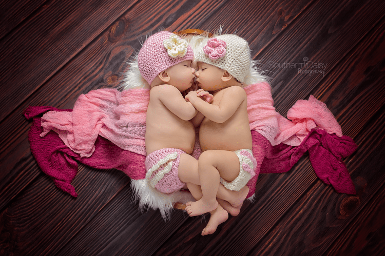 twin baby girls cuddling in basket - nashville newborn photographer