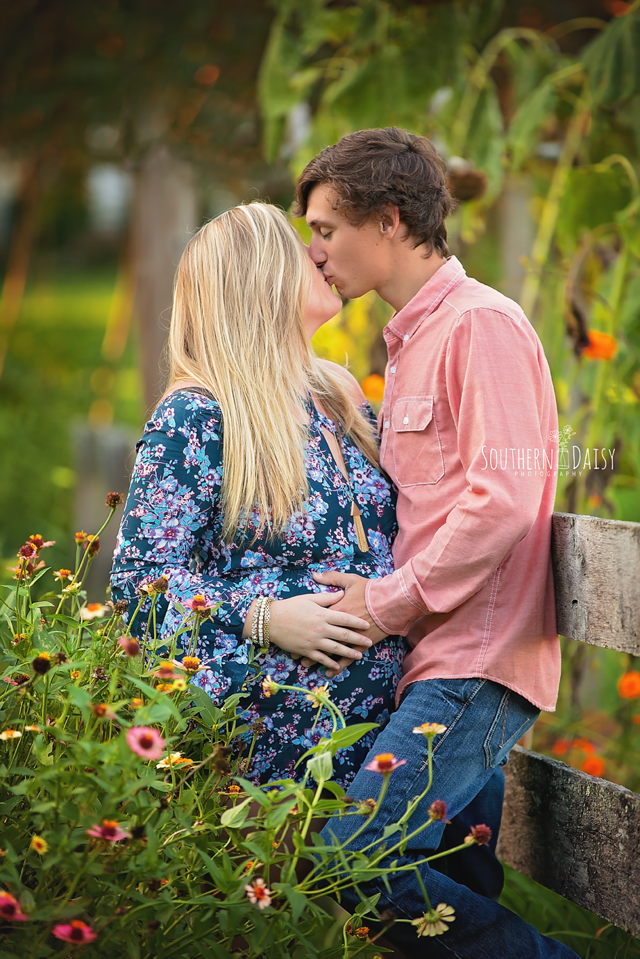 expectant parents kissing in flower garden - nashville maternity photography