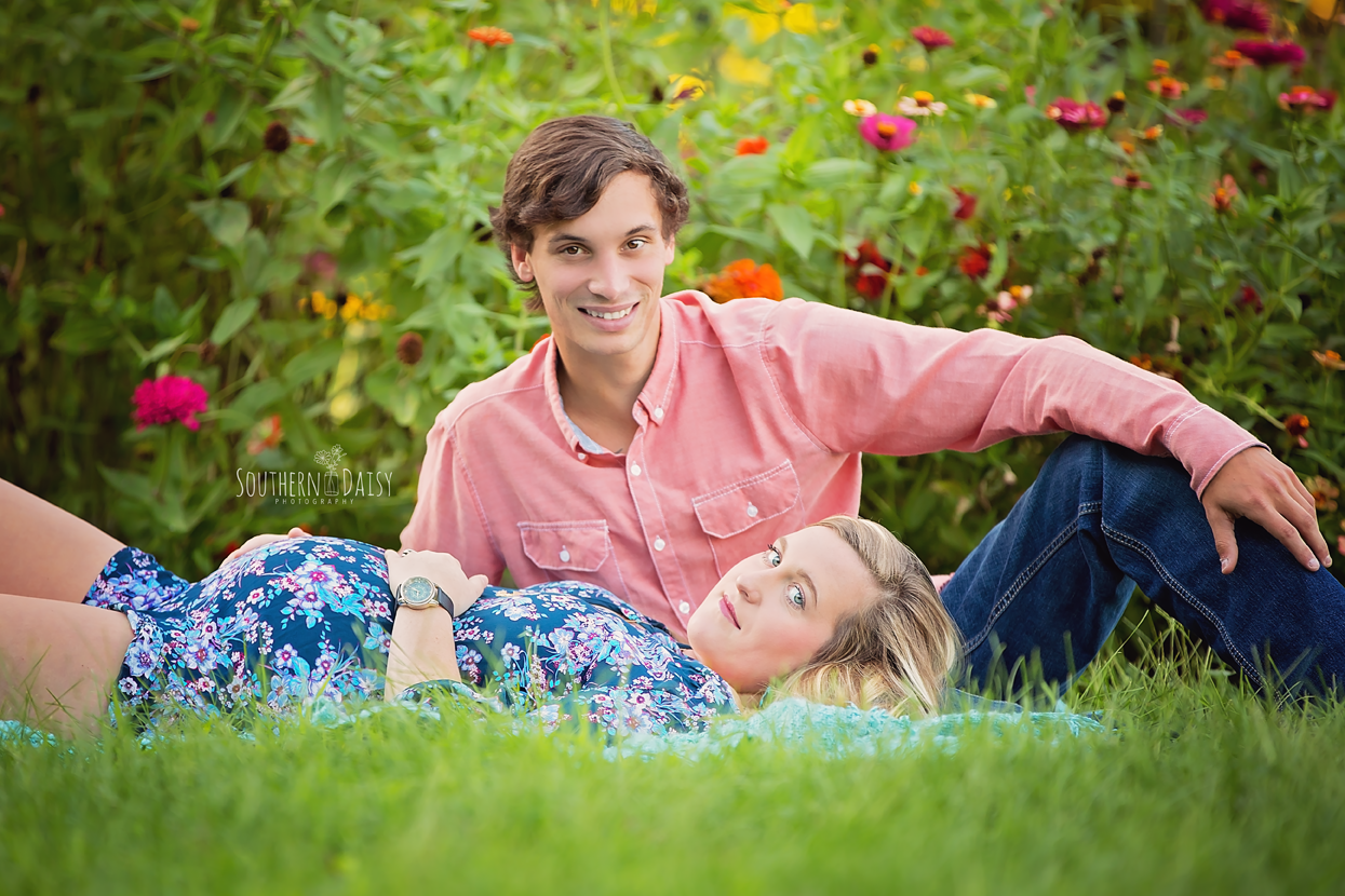 expecting mother and father in flower garden - Nashville Maternity Photographer